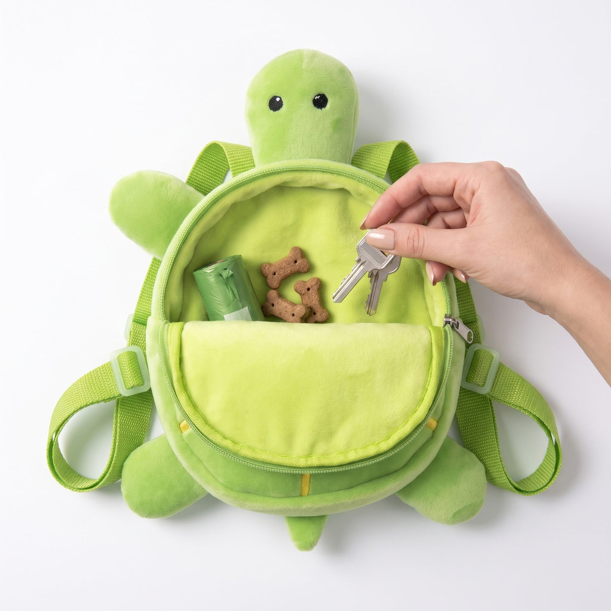 Turtle shell unzipped with poop bags, treats and keys inside